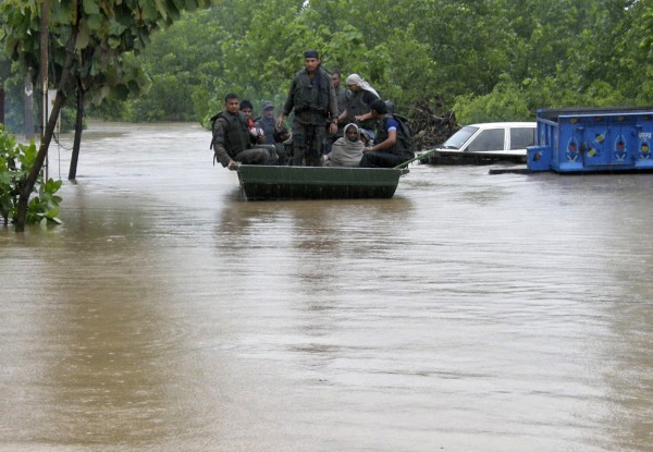 Indian army soldiers rescue stranded villagers in a boat after floods triggered by heavy rains at Odhri village