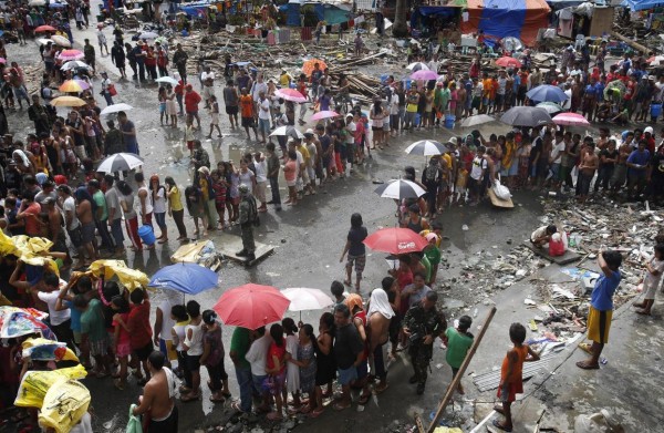131114-supertyphoon-haiyan-philippines-tacloban-queue-food-001