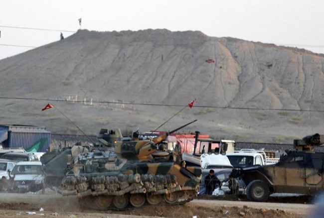 141006-turky-forces-isis-flag-kobani-town