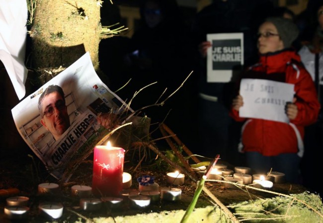 People pay tribute to the victims of a shooting by gunmen at the offices of weekly satirical magazine Charlie Hebdo in Paris, in front of the European Parliament in Brussels