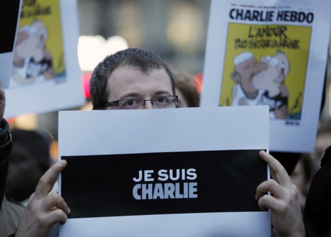 A man holds a placard which reads "I am Charlie" during a gathering at the Place de la Republique in Paris