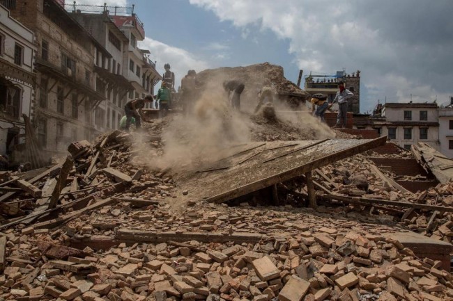 KATHMANDU, NEPAL - APRIL 27:  Volunteers and emergency workers search for bodies buried under the debris of one of the temples at Basantapur Durbar Square on April 27, 2015 in Kathmandu, Nepal. A major 7.8 earthquake hit Kathmandu mid-day on Saturday, and was followed by multiple aftershocks that triggered avalanches on Mt. Everest that buried mountain climbers in their base camps. Many houses, buildings and temples in the capital were destroyed during the earthquake, leaving over 2 thousand dead and many more trapped under the debris as emergency rescue workers attempt to clear debris and find survivors.  (Photo by Omar Havana/Getty Images)