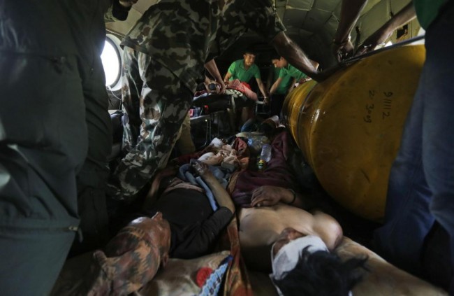 Nepalese victims of Saturdays earthquake lie inside an Indian air force helicopter as they are evacuated from Trishuli Bazar to Kathmandu airport in Nepal, Monday, April 27, 2015. The death toll from Nepal's earthquake is expected to rise depended largely on the condition of vulnerable mountain villages that rescue workers were still struggling to reach two days after the disaster.  (AP Photo/Altaf Qadri)