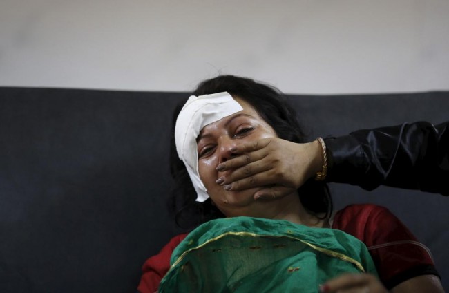 An injured woman cries after hearing news of a family member who died during an earthquake at a trauma center in Kathmandu, Nepal April 26, 2015. Rescuers dug with their bare hands and bodies piled up in Nepal on Sunday after the earthquake devastated the heavily crowded Kathmandu Valley, killing more than 2,200 people, and triggered a deadly avalanche on Mount Everest. (REUTERS/Adnan Abidi)