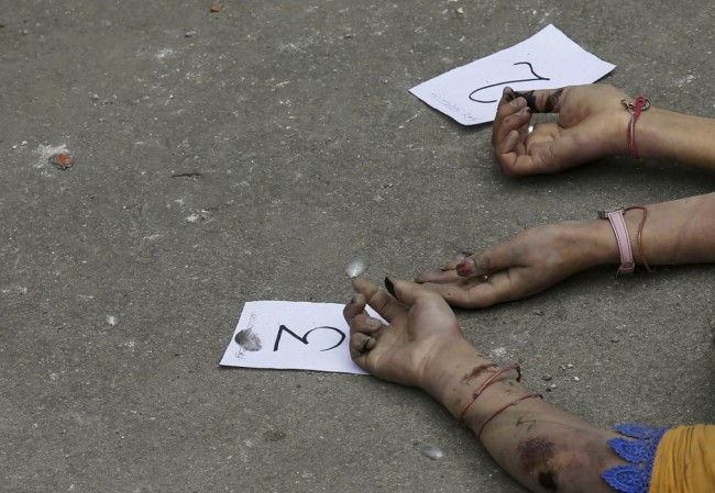 Identification numbers are seen next to dead bodies after an earthquake struck, outside a hospital in Kathmandu, Nepal April 26, 2015. Rescuers dug with their bare hands and bodies piled up in Nepal on Sunday after the earthquake devastated the heavily crowded Kathmandu Valley, killing more than 2,200 people, and triggered a deadly avalanche on Mount Everest. (REUTERS/Adnan Abidi)