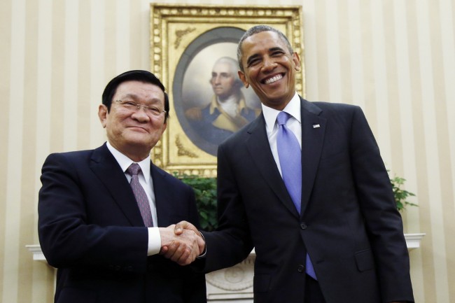 FILE - In this July 25, 2013, file photo, U.S. President Barack Obama poses with Vietnam's President Truong Tan Sang for a photo during their meeting in the Oval Office at the White House in Washington. Bilateral friendship between the U.S. and Vietnam was formalized in 2013, when Truong Tan Sang visited the White House and with Obama launched a “Comprehensive Partnership” for cooperation in political and diplomatic relations, trade and economic ties, defense, the war legacy and many other issues. (AP Photo/Charles Dharapak, File)