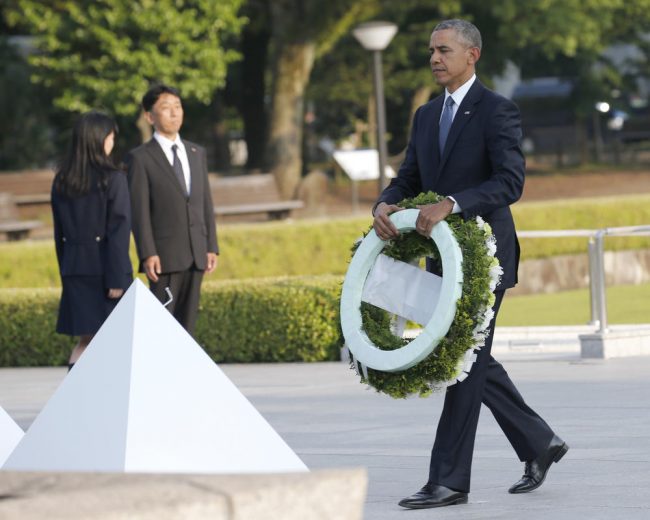 U.S. President Barack Obama walks to lay a wreath at Hiroshima Peace Memorial Park in Hiroshima, western, Japan, Friday, May 27, 2016. Obama on Friday became the first sitting U.S. president to visit the site of the world's first atomic bomb attack, bringing global attention both to survivors and to his unfulfilled vision of a world without nuclear weapons. (AP Photo/Shuji Kajiyama)