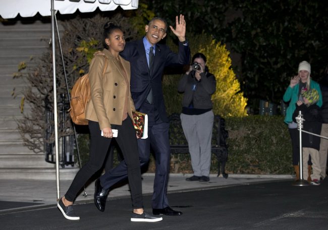 President Barack Obama waves as he and his daughter Sasha walk from the White House to board Marine One, Friday, Dec. 18, 2015, in Washington, for the short trip to Andrews Air Force Base en route to San Bernardino, Calif. (AP Photo/Carolyn Kaster)