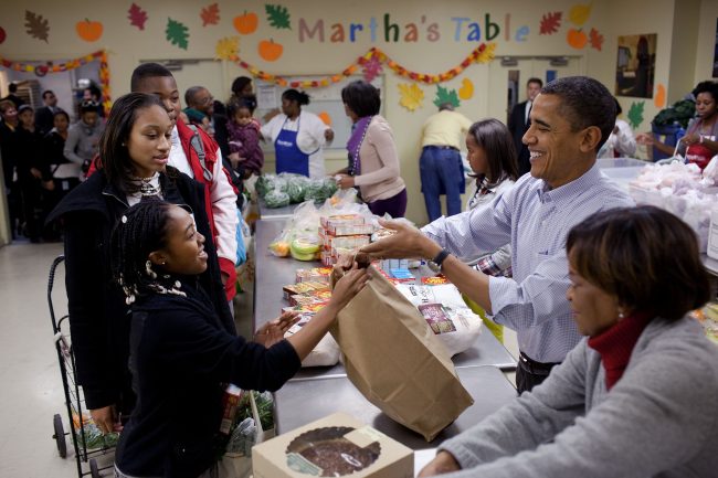 President Barack Obama, First Lady Michelle Obama, daughters Sasha and Malia, and mother-in-law Marian Robinson help distribute Thanksgiving food items at MarthaÕs Table, a food pantry in Washington, D.C., Nov. 24, 2010. (Official White House Photo by Pete Souza)
